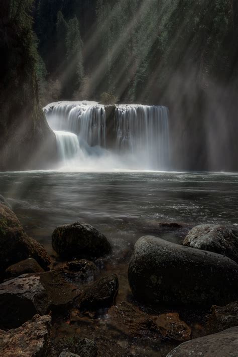 Light Rays Shining On A Waterfall In The Ford Pinchot National