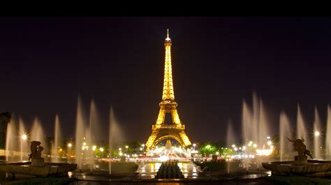 Paris Eiffel Tower With Yellow Lights And Water Fountain With