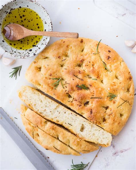 Focaccia bread with a crisp chewy crust, airy soft center, and amazing garlic rosemary topping. No Knead Roasted Garlic Focaccia Recipe | The Flavours of Kitchen