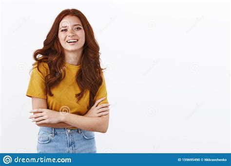 Ambitious Cute Redhead Female Student In Yellow T Shirt Cross Arms Like