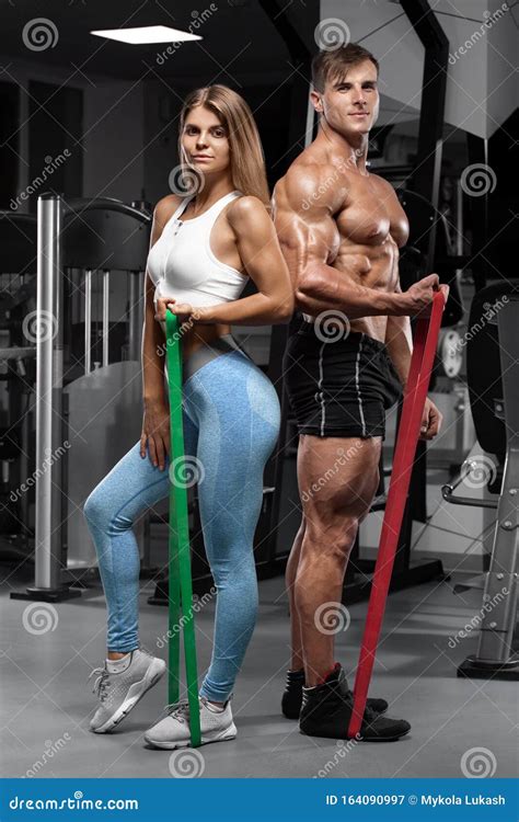 Sporty Couple Workout With Dumbbells Muscular Man And Woman Showing