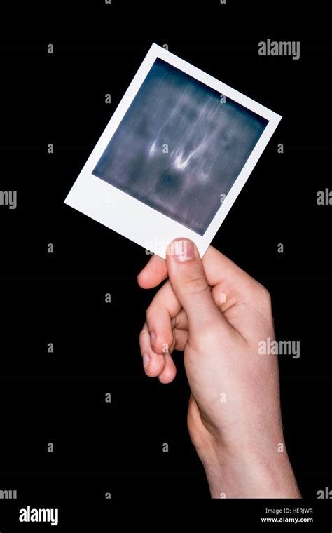 A Hand Holding An Undeveloped Polaroid Photograph Stock Photo Alamy