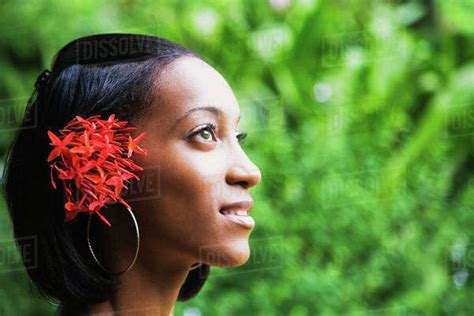 African Woman With Flowers In Hair Looking Up Stock Photo Dissolve