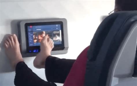 Video Disgust As Airline Passenger Uses Bare Feet To Swipe Touch Screen Tv