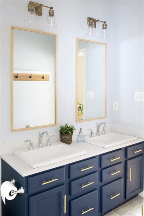 Stock vanity made over with a coat of navy paint and gold hardware. Navy Bathroom Vanity | Home Inspiration