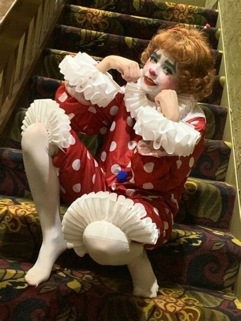 A Creepy Clown Sitting On The Stairs
