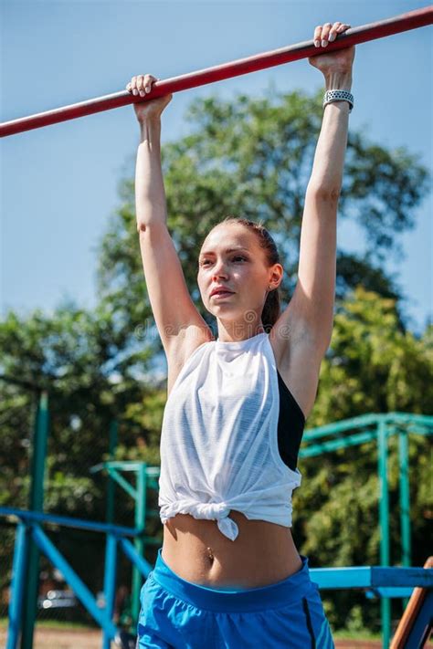 Girl On Street Workout She Pull Ups Herself Up On Bar On Sports Ground
