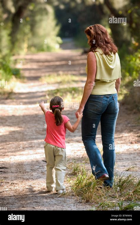 Mother And Child Walking In Park On Trail Stock Photo Alamy