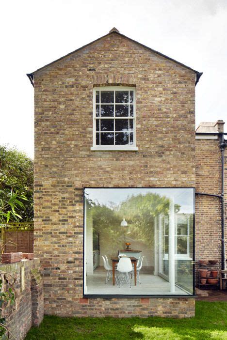 A Large Window Wraps Around One Corner Of This Brickwork Extension To A