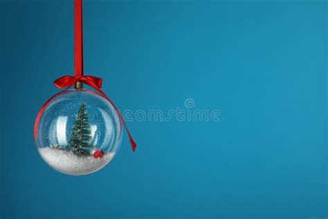 Beautiful Christmas Snow Globe Hanging On Blue Background Space For