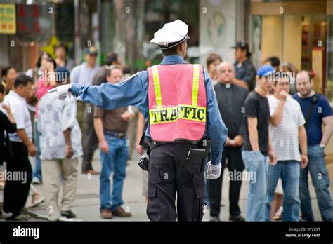 A Traffic Cop Directs Traffic At An Intersection In New York City Stock