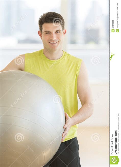 Handsome Man Holding Fitness Ball At Gym Stock Photo Image Of Beauty