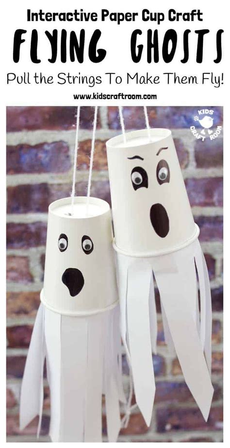 Two Paper Cups With Googly Eyes And Mouths Hanging From The Ceiling