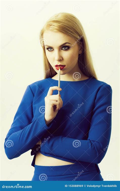 Woman With Lipstick Brush On Red Lips Wearing Blue Dress Stock Image