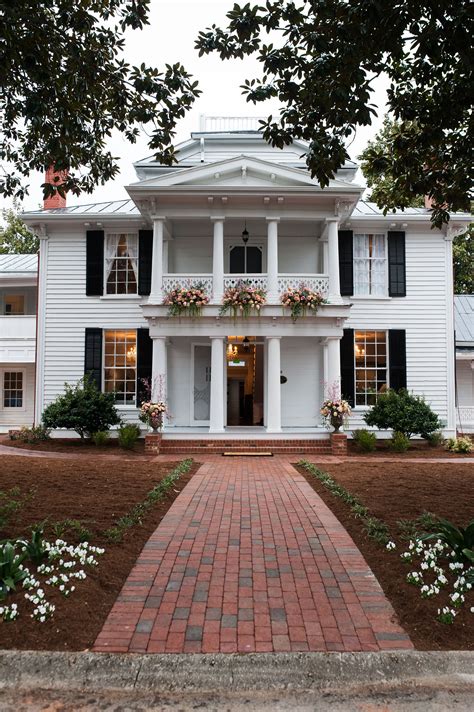 Beautiful White Two Story Colonial House With A Double Balcony Flower