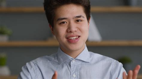 Webcam Pov Portrait Of Young Confiden Asian Man Talking To Camera