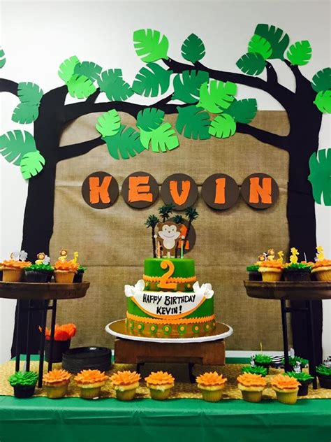 jungle themed birthday party with diy decorations backdrop and yummy desserts jungle party