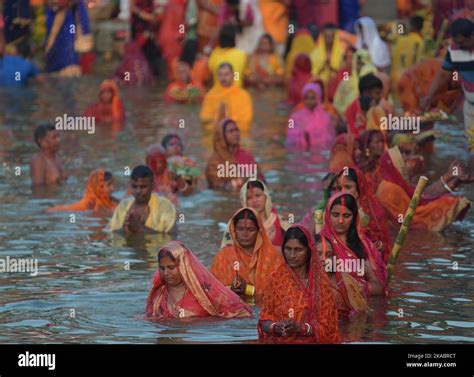 Hindu Devotees Perform Rituals And Offer Prayers To The Sun God On The