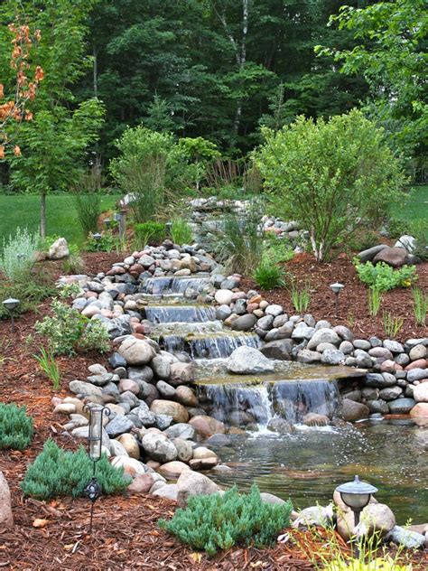 A backyard pond waterfall can be a beautiful addition to your backyard pond and garden. Waterfall Designs | HGTV