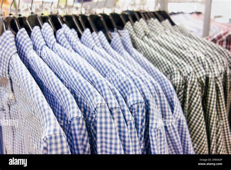 Checkered Shirts Hanging On Hangers In A Clothing Store Stock Photo Alamy