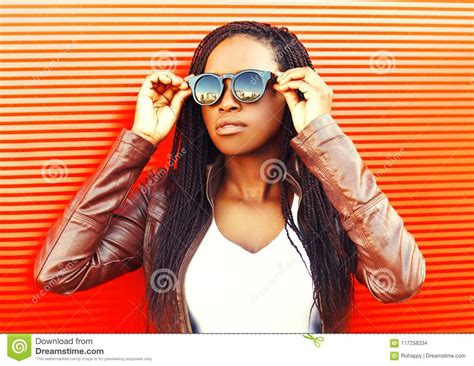 Stylish Young African Woman Wearing A Jacket Sunglasses In City Stock