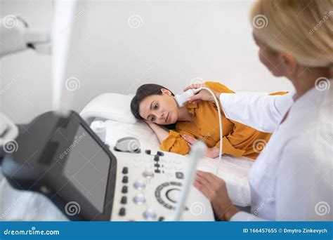 Ultrasound Specialist In White Robe Making Lymph Node Ultrasound Test