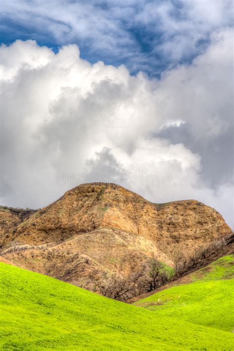 Verdant Green Mountains And Hills With Blue Sky And Rolling Clouds