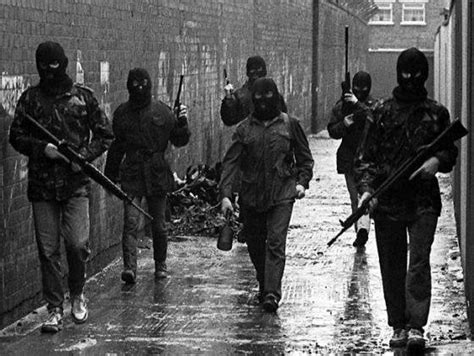 A Squad Of Ira Volunteers Moving Through A Belfast Alleyway The