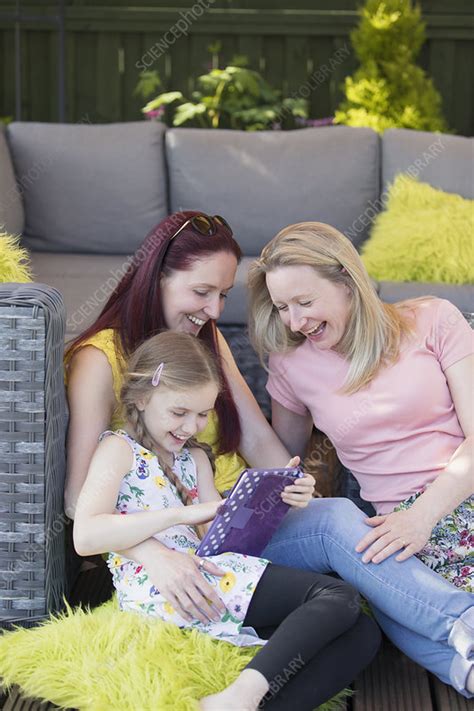 lesbian couple and daughter using digital tablet stock image f022 7415 science photo library