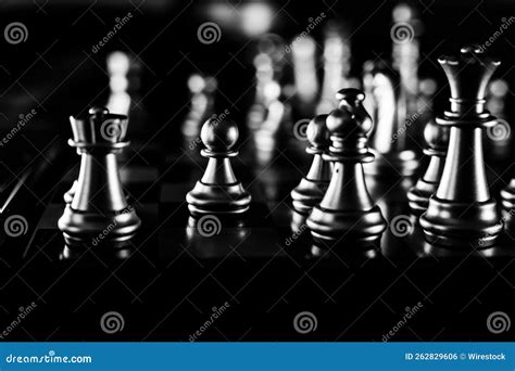 Grayscale Shot Of A Chess Board With The Pieces Lined On Top Stock