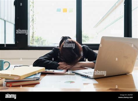 Stressed Business Woman Hard Working Until Morning And Tired And Sleep At Table In Office While