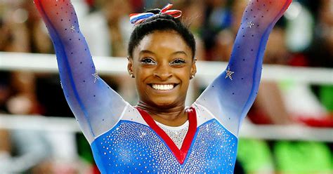 I encourage readers who aren't aware of it to dive into her personal story on being adopted. Simone Biles Team USA Rio Flag Bearer