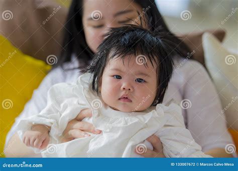 Lifestyle Portrait Of Young Happy And Cute Asian Chinese Woman Playing And Holding Sweet