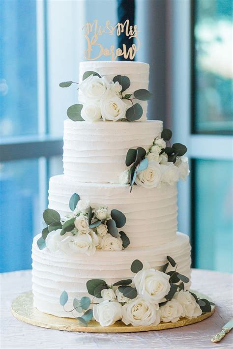 Elegant White Wedding Cake With Greenery And Roses