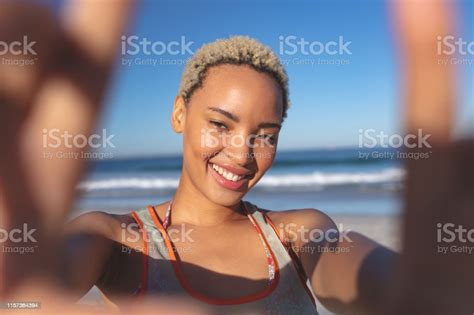 Beautiful Woman Standing On The Beach Stock Photo Download Image Now