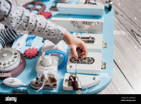 Cute Left Handed Toddler Baby Playing With Busy Board At Home Busy
