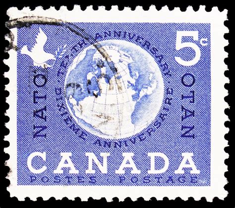 postage stamp printed in canada shows globe showing nato countries nato 10th anniversary serie