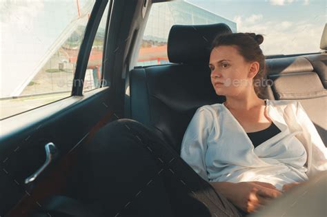 Woman Is Sitting In The Back Seat Of The Car Stock Photo By Arthurhidden