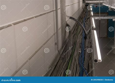 Electrical Cables Hang From The Ceiling In A Cable Duct Stock Photo