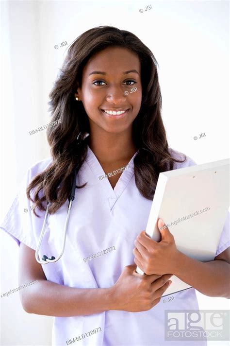 Black Nurse Carrying Clipboard Stock Photo Picture And Royalty Free