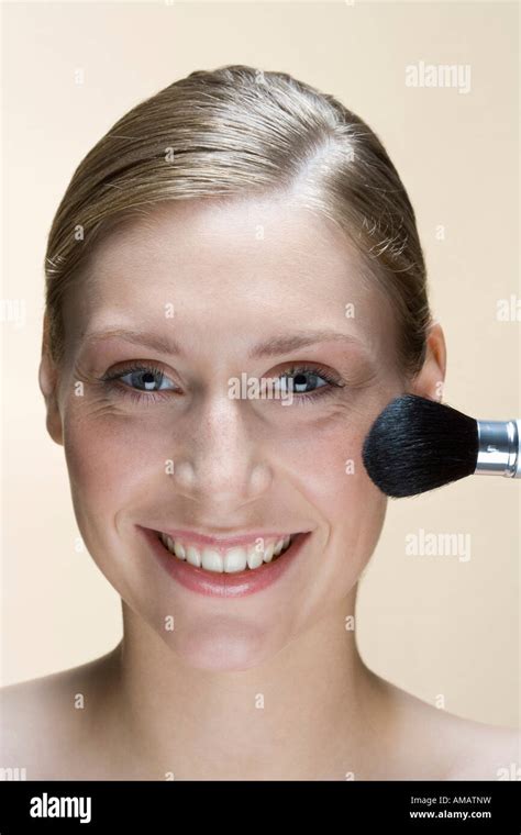 A Woman Applying Face Powder Stock Photo Alamy
