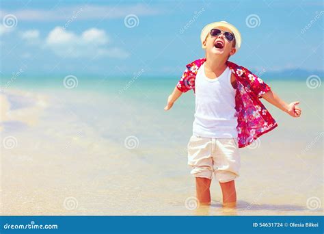 Happy Fashionable Kid Boy Enjoys Life On Summer Beach Stock Photo