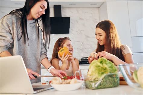 On The Kitchen Female Lesbian Couple With Little Daughter Spending Time Together At Home Stock