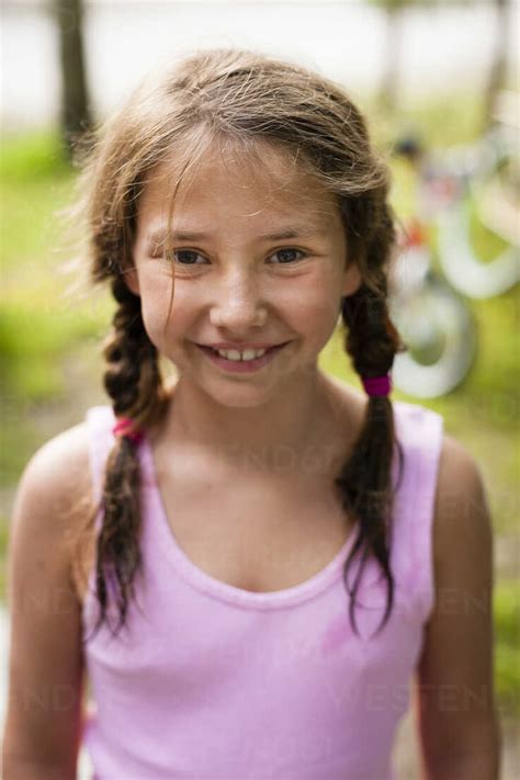 High Angle Portrait Of Young Girl With Pigtails Looking At Camera
