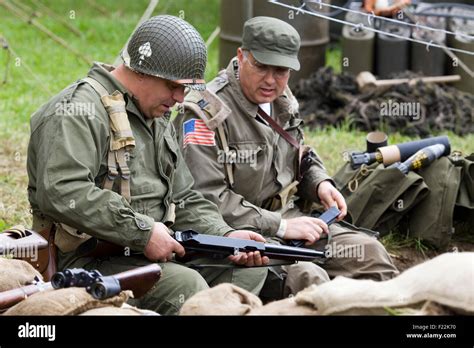 World War 11 Soldiers Checking Weapons On The Battlefield Stock Photo
