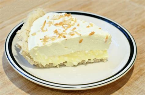 A Piece Of Pie On A Plate With White Frosting And Toast Crumbs