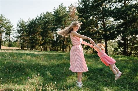 Premium Photo Portrait Of A Mother Throws Up And Spins The Daughter