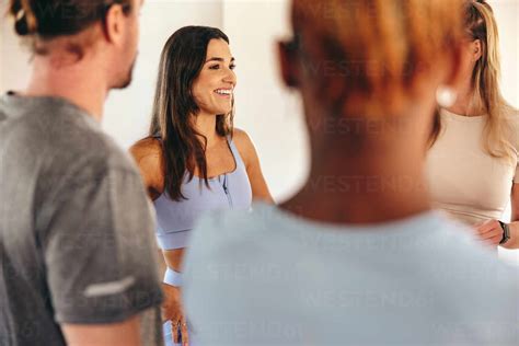 Fitness People Talking To Each Other While Standing In A Circle In A