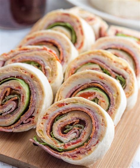 She feeds the baby with a spoon. Italian Pinwheels {A Delicious Party Appetizer for a Crowd}