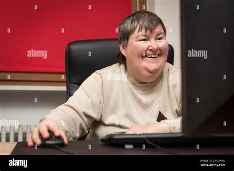 Mentally Disabled Woman Sitting At The Computer Education And Learning